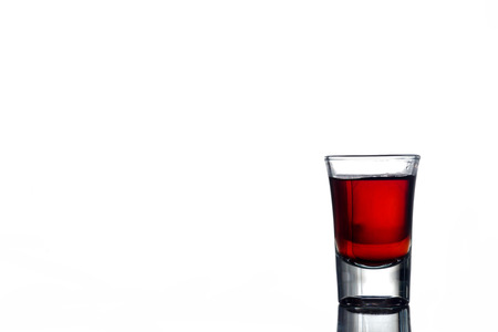 Glass of alcohol on a white background. Free space for textの写真素材