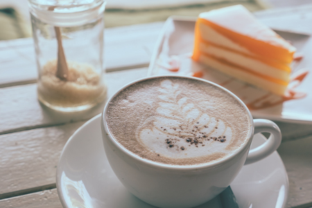 Coffee and orange cake on wooden table, Soft focus, Vintage toneの写真素材