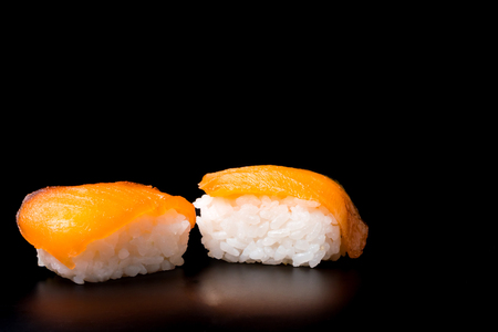 Sushi, japanese food, rice with salmon on black background.の写真素材
