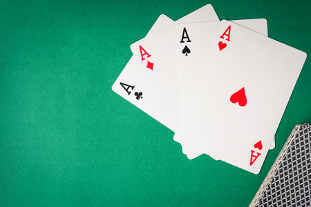 Playing cards, Four aces on green background. Free space for textの写真素材
