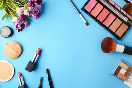 Top view of cosmetics set for makeup on a blue background. Free space for text.の写真素材