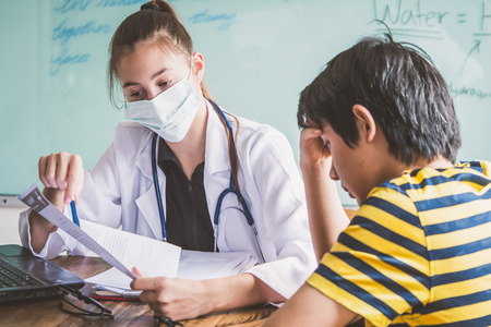 Female doctor explaining diagnosis to her patient. Young pretty future doctor on classes learning how to treat a patientの写真素材