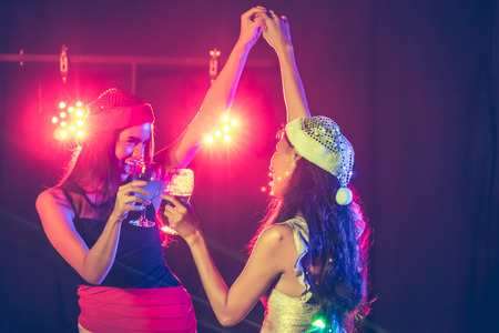 new year party, holidays, celebration, nightlife and people concept - Beautiful girls having fun at a party.の写真素材