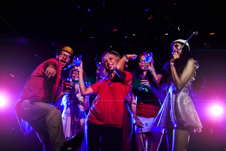 new year party, holidays, celebration, nightlife and people concept - Young people having fun dancing at a party.の写真素材