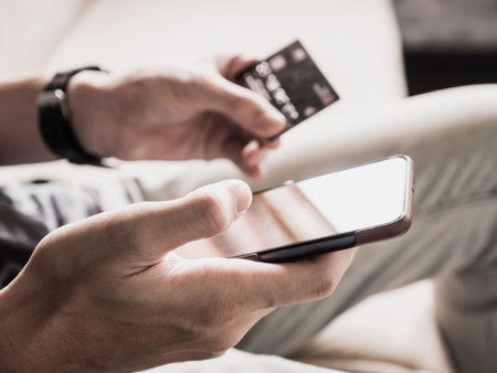 Close up of male hands using smartphone and holding credit card. Online shopping concept. selective...