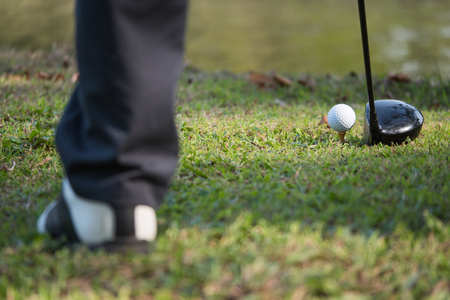 Close up of golf ball on a tee with the driver positioned ready to hit the ball.の写真素材