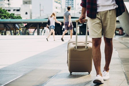 Close up of traveller with luggage on city street. Vacation and travel conceptの写真素材