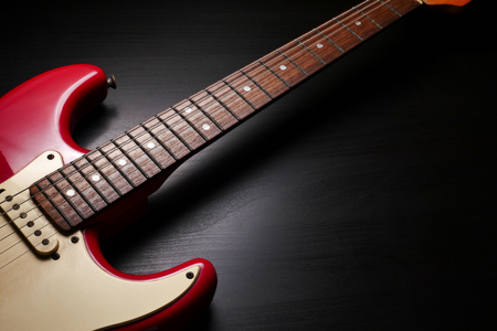 Close up of Electric guitar body and neck detail on black background.の写真素材