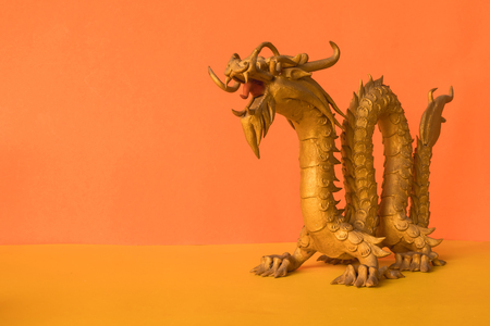 Golden Dragon Statue is a symbol of wealth and power in the faith of Chinese on color background. copy spaceの写真素材