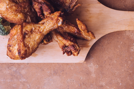 Top view of Fried chicken legs and wings on wooden tray.の写真素材
