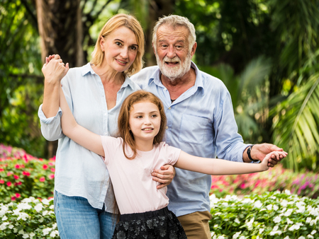 Portrait of Happy family having fun together in a park.の写真素材