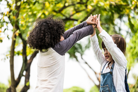 Little boy and girl playing together in a parkの写真素材
