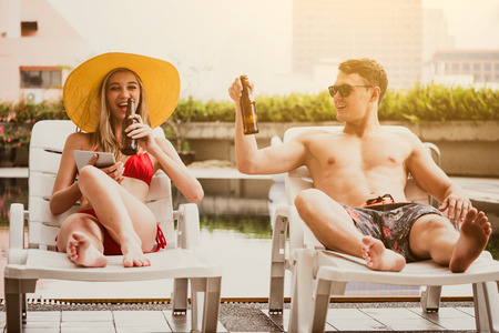 Young couple enjoying summer time at swimming pool.の写真素材