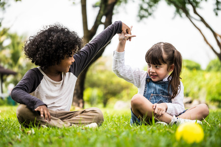 Little boy and girl playing together in a parkの写真素材