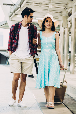 Couple Asian travelers are walking and enjoying vacations on city street. Travel conceptの写真素材