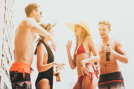 Group of friends enjoying vacation in summer time. Young people having fun dancing at the pool partyの写真素材