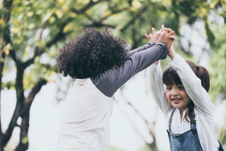 Little boy and girl playing together in a park