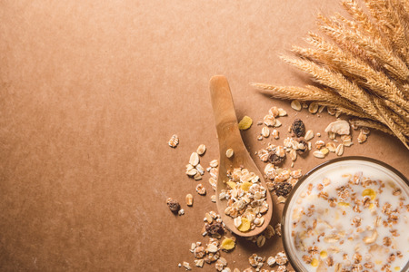A cup of milk with cereal on wooden table. Healthy breakfast concept. copy space. top viewの写真素材