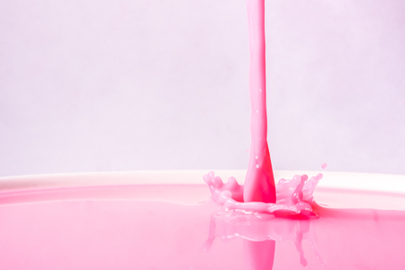 Splash of strawberry milk from the glassの写真素材