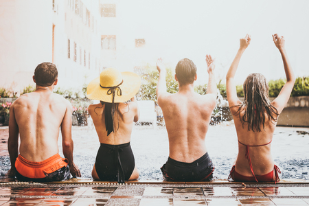 Group of friends enjoying summer time in a swimming pool.の写真素材