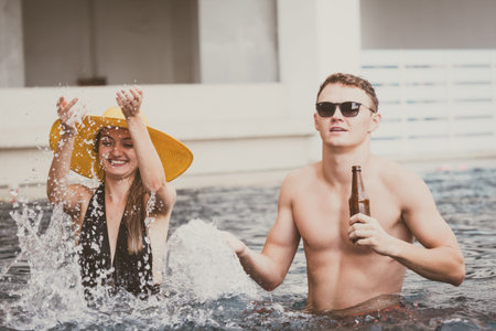Young couple having fun dancing at the pool party