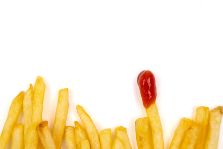 Top view of French fries with ketchup on a white background. copy space