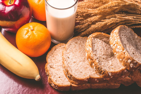 Healthy breakfast with whole wheat bread, milk and fruits on the table