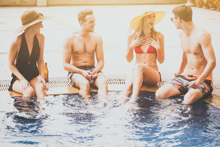 Group of friends enjoying summer time in a swimming pool.の写真素材