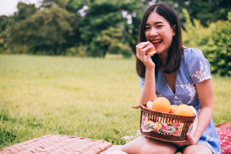 Portrait of beautiful woman enjoying picnic in a park.