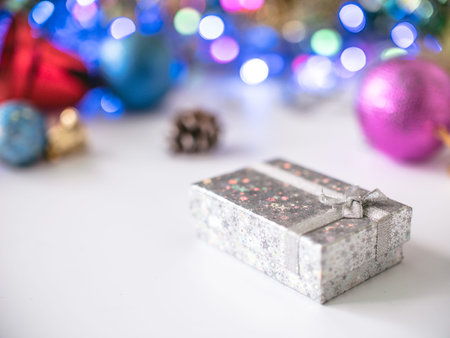 Gift box with blur bokeh of christmas decoration backgroundの写真素材