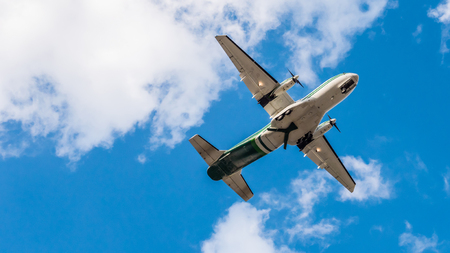 Airplane flying on blue sky.の写真素材