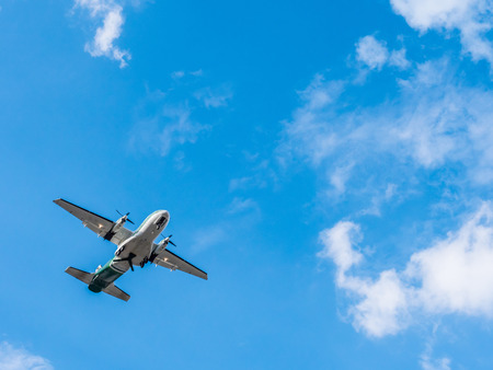 Airplane flying on blue sky.の写真素材
