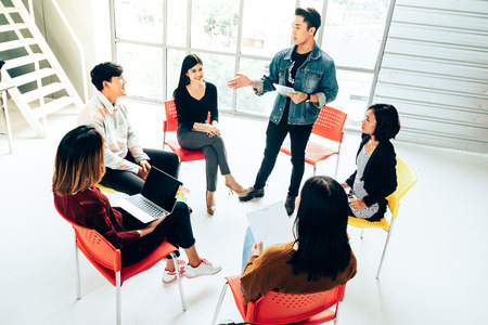 Coworkers discussing in meeting room at the officeの写真素材