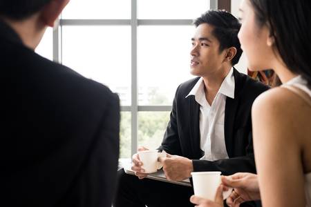 Asian Businesspeople are paying attention while meeting at the office.の写真素材