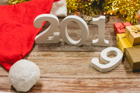 Top view of Christmas hat, 2019 number and gift boxes on woodenの写真素材