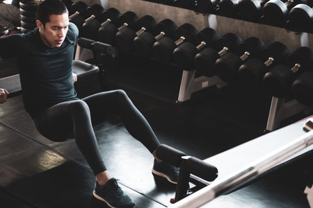 Attractive young man working out at the gym.