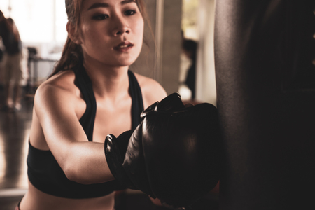Young athletic girl fighter trains in the gym.の写真素材