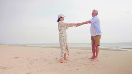 Happy couples standing and holding hands together on the beach.