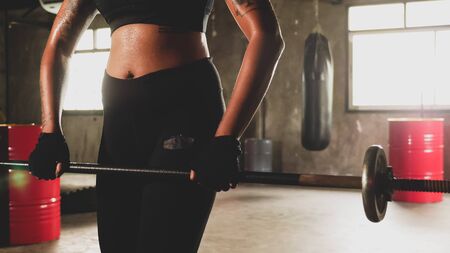 Asian woman doing weight lifting at the gym.の写真素材