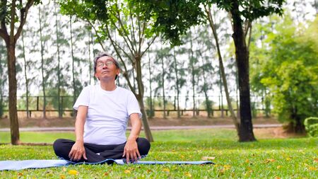 Asian man doing yoga at the park.の写真素材
