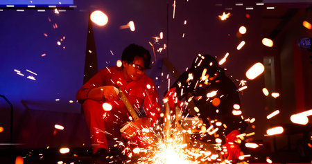 Male welders working together at site.