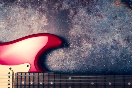 A red electric guitar on a grunge background.の写真素材