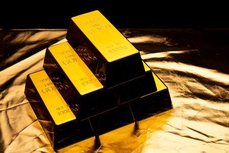 Stack of gold bars on shiny yellowの写真素材
