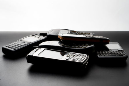 Old and obsoleted cellphones on a black