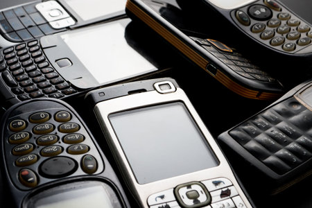 Old and obsoleted cellphones on a black