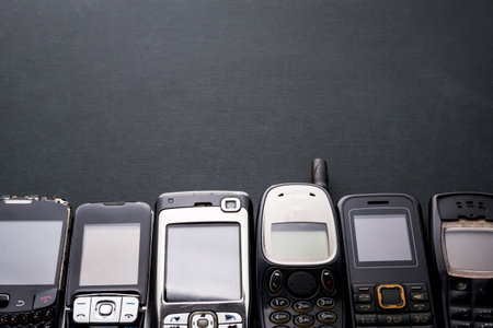 Old and obsoleted cellphones on a black