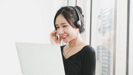 Happy business woman working by video conference with laptop from home.