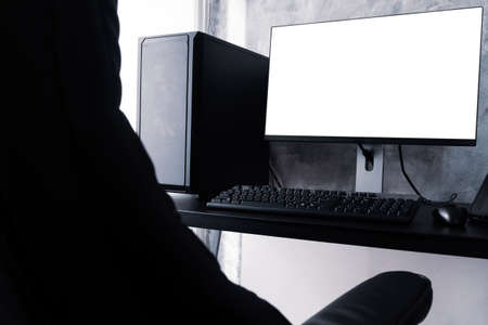 Black computer with white screen monitor on the desk.の写真素材