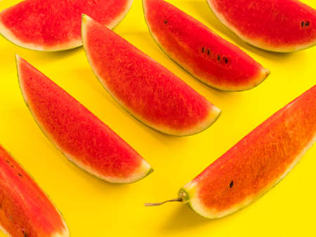 Fresh ripe watermelon slices on yellow background.の写真素材