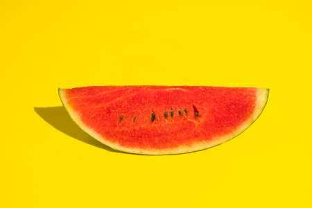 Fresh ripe watermelon slice on yellow background.の写真素材